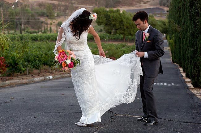 Groom checking the bride's wedding dress at a vinery in Temecula